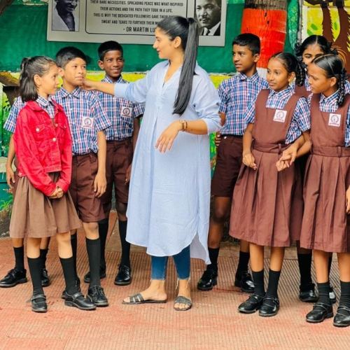 A visitor engaging with students