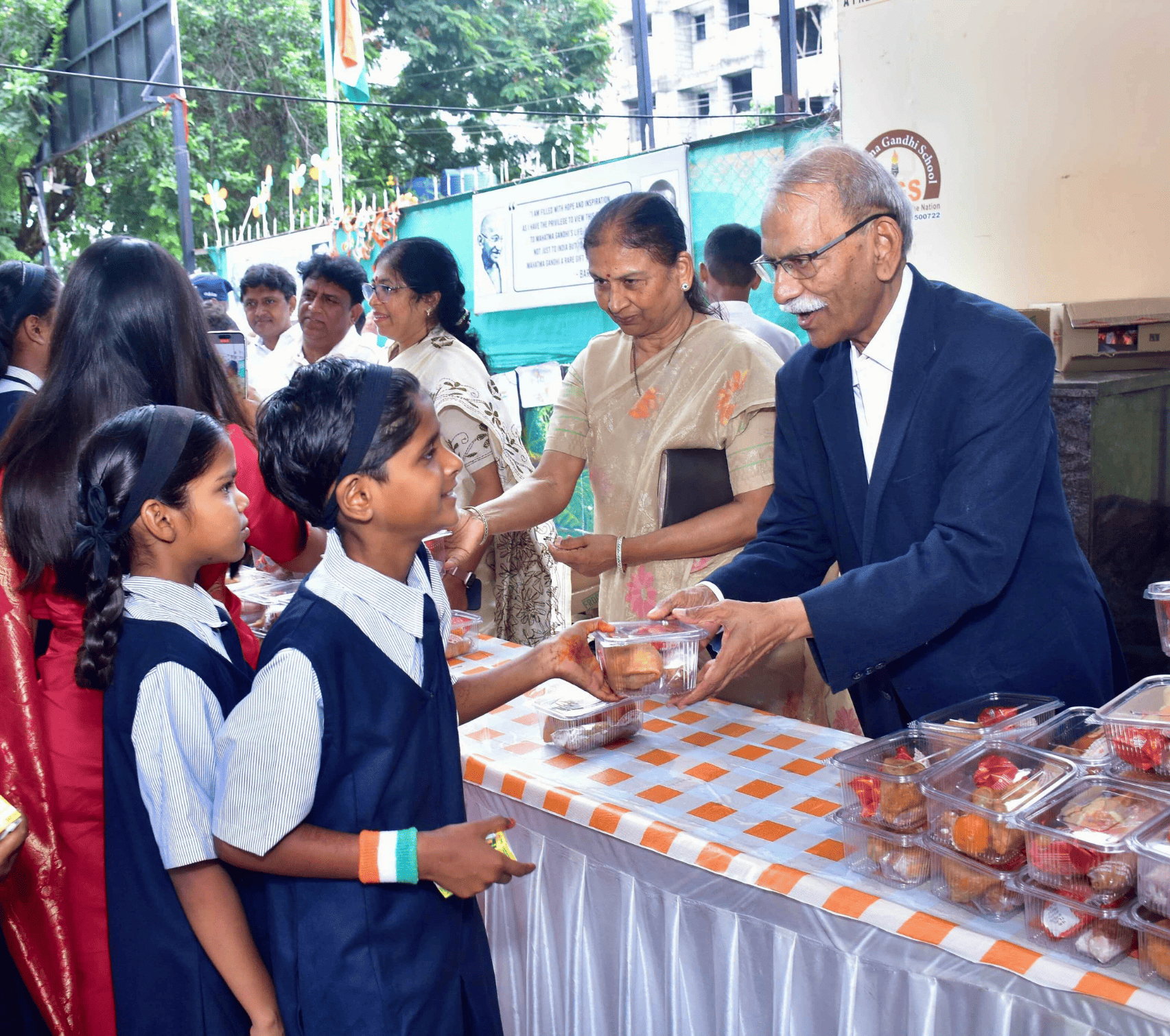 Students receiving sweets at a school celebration